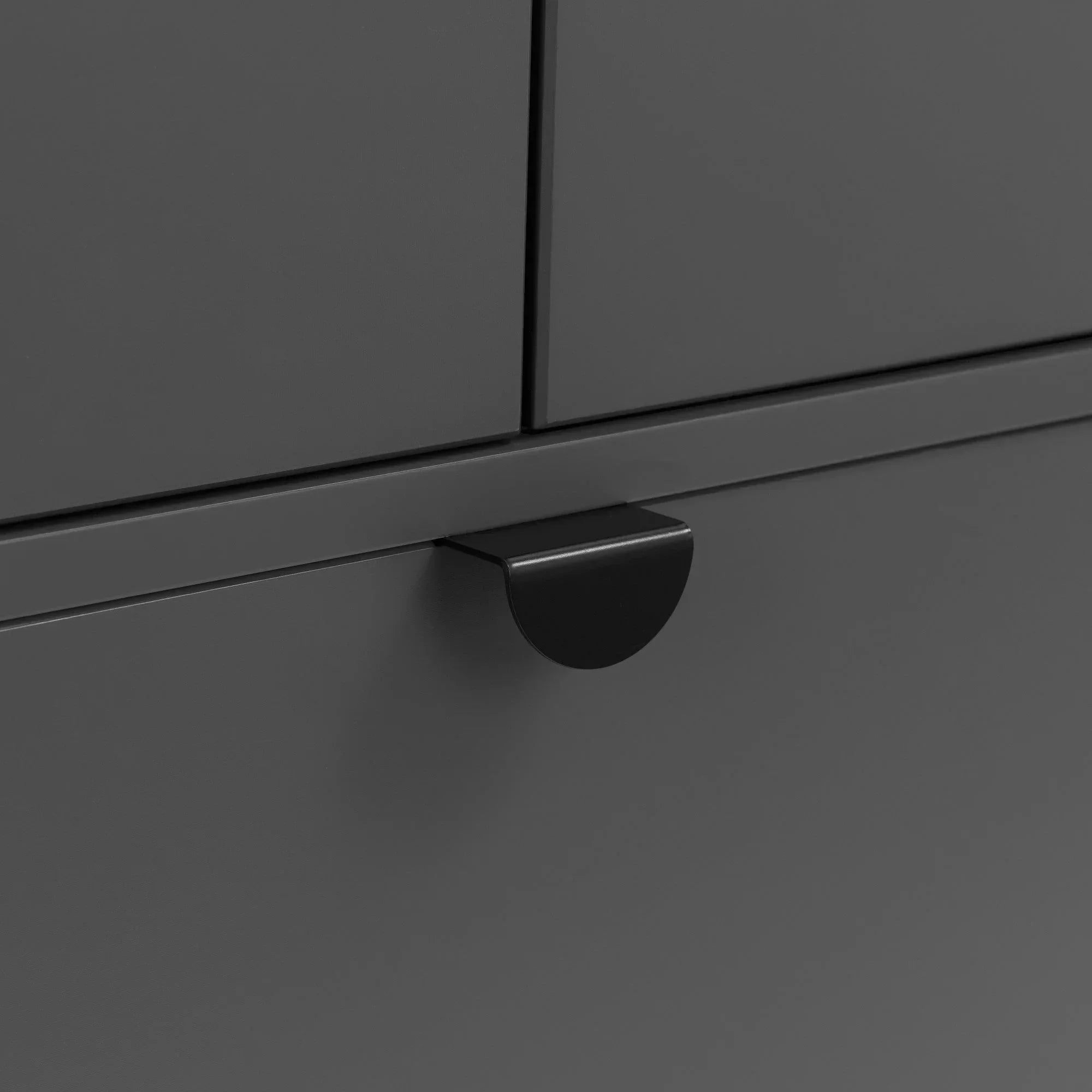 Matte black metal drawer handle on dark grey cabinet front