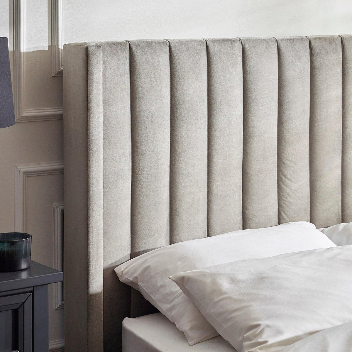 Upholstered velvet bed with vertical panel headboard in neutral bedroom setting