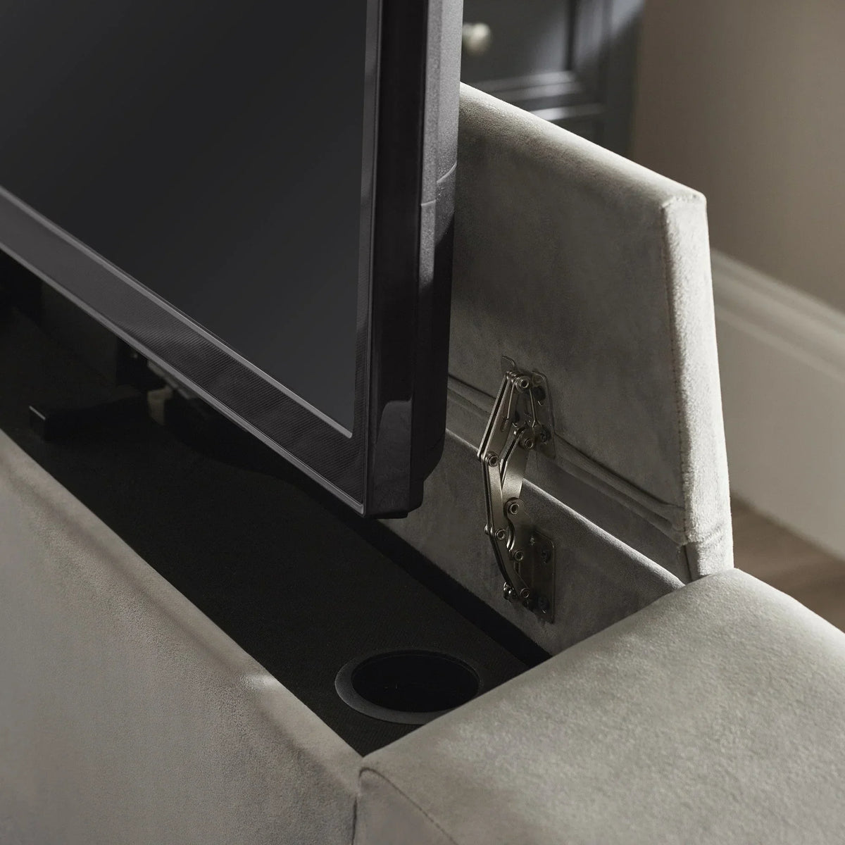 Close view of upholstered TV bed frame with integrated lift mechanism and storage compartment
