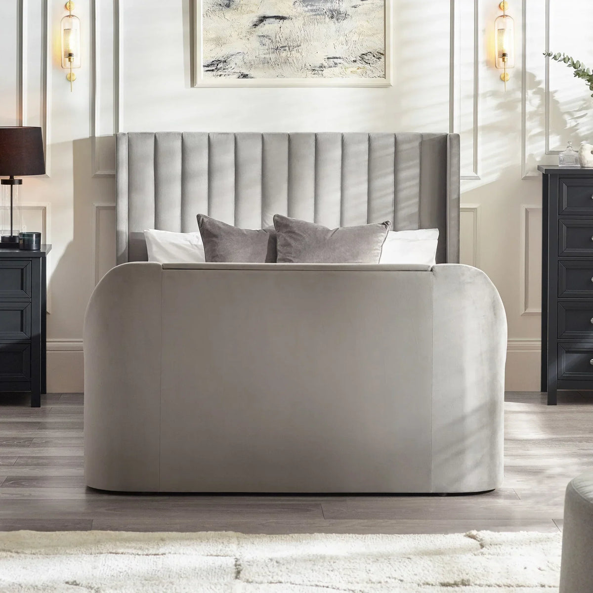 Grey upholstered bed frame with vertical headboard in modern bedroom, matching cushions visible