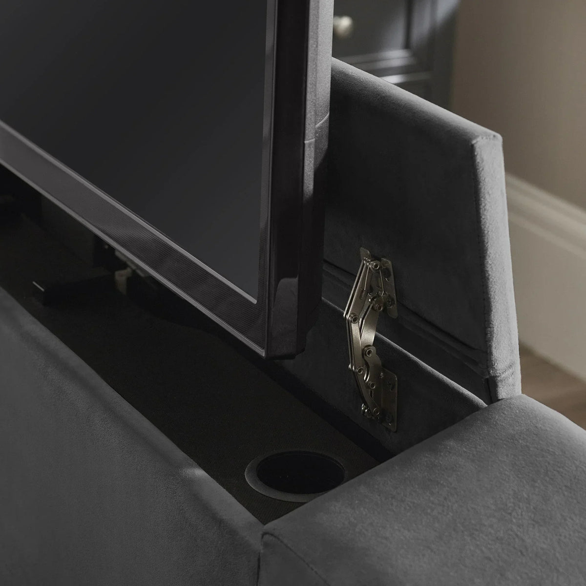 Close-up of upholstered TV bed footboard with built-in pop-up television mechanism