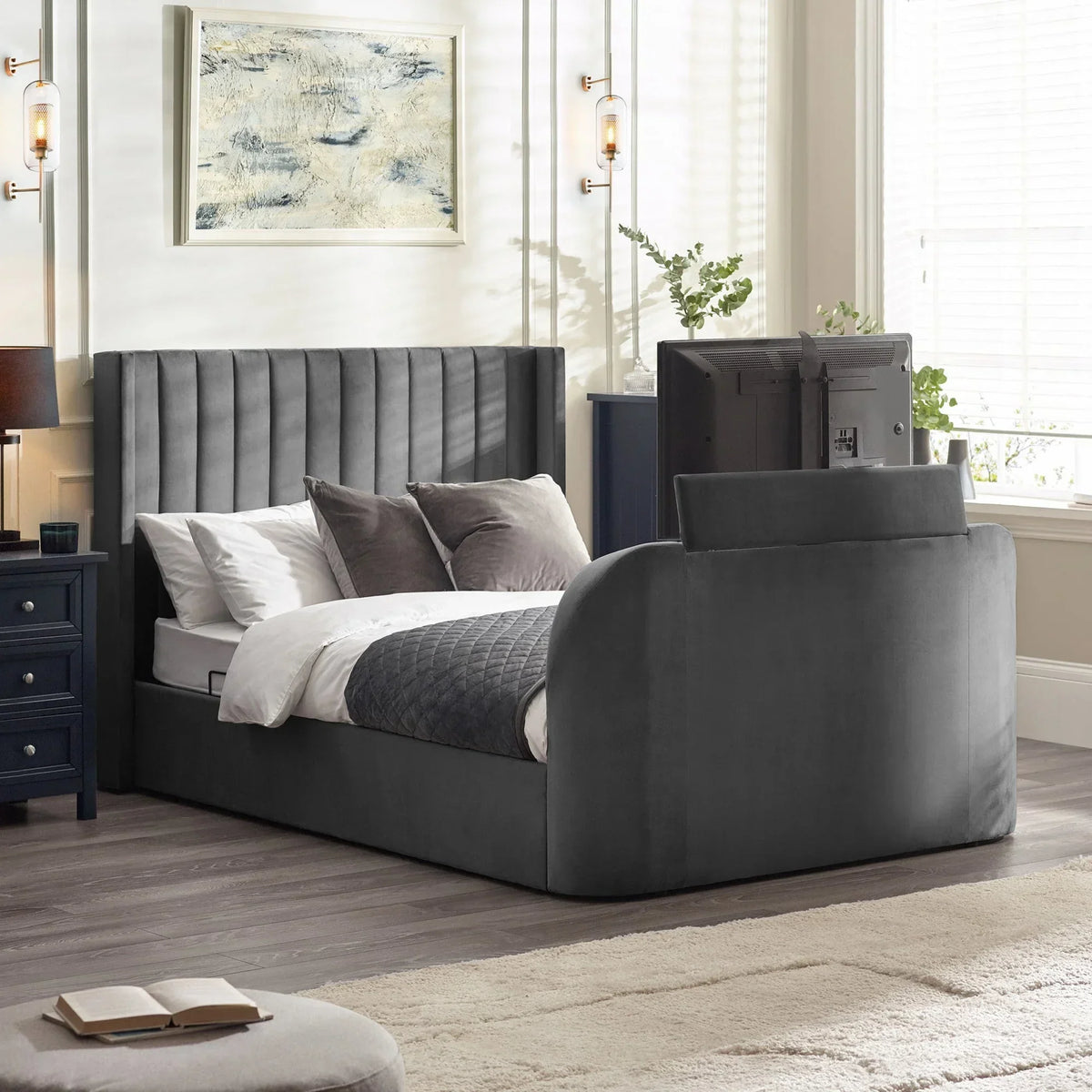 Grey upholstered TV bed with tall headboard and built-in footboard screen in modern bedroom