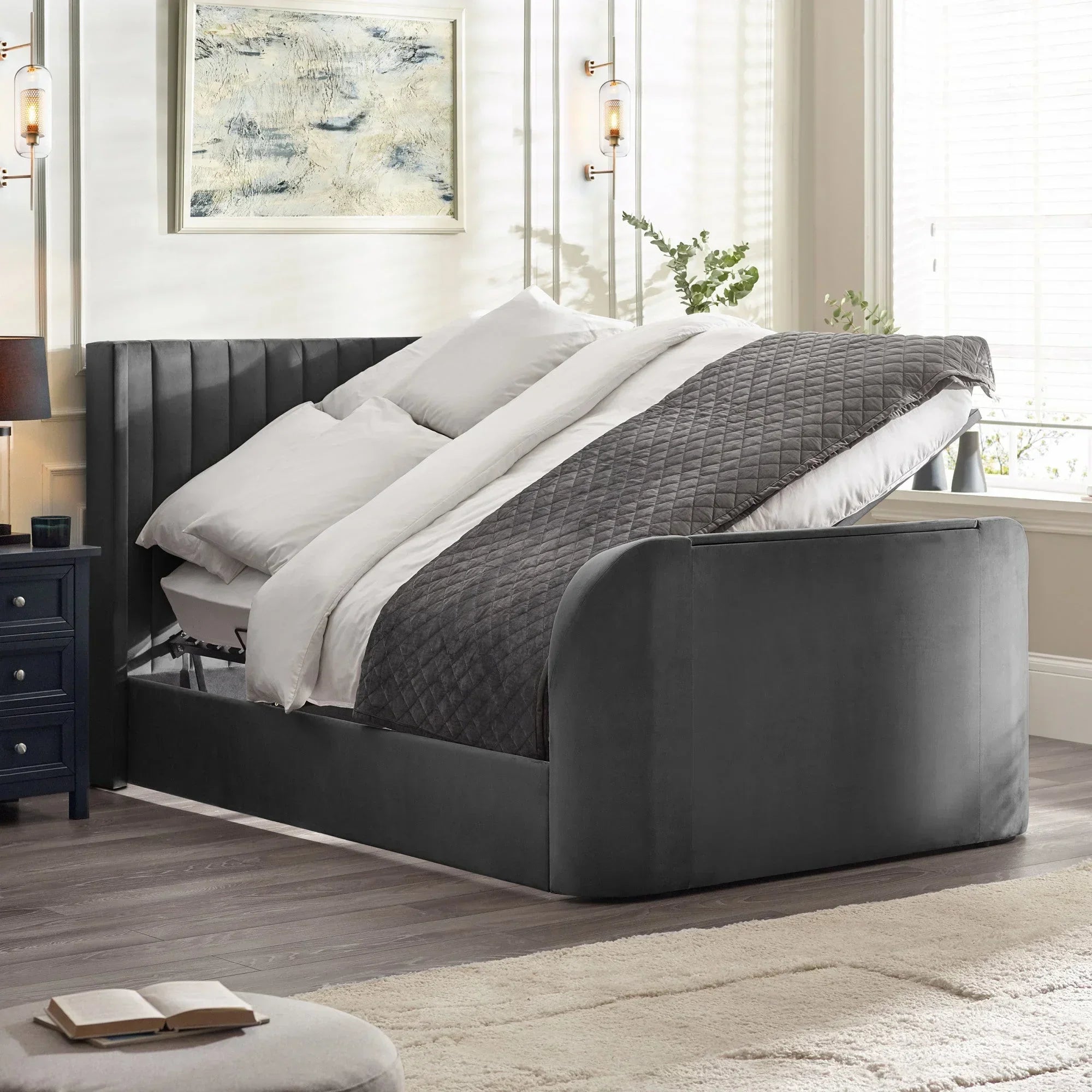Dark grey upholstered ottoman storage bed with quilted blanket in modern bedroom