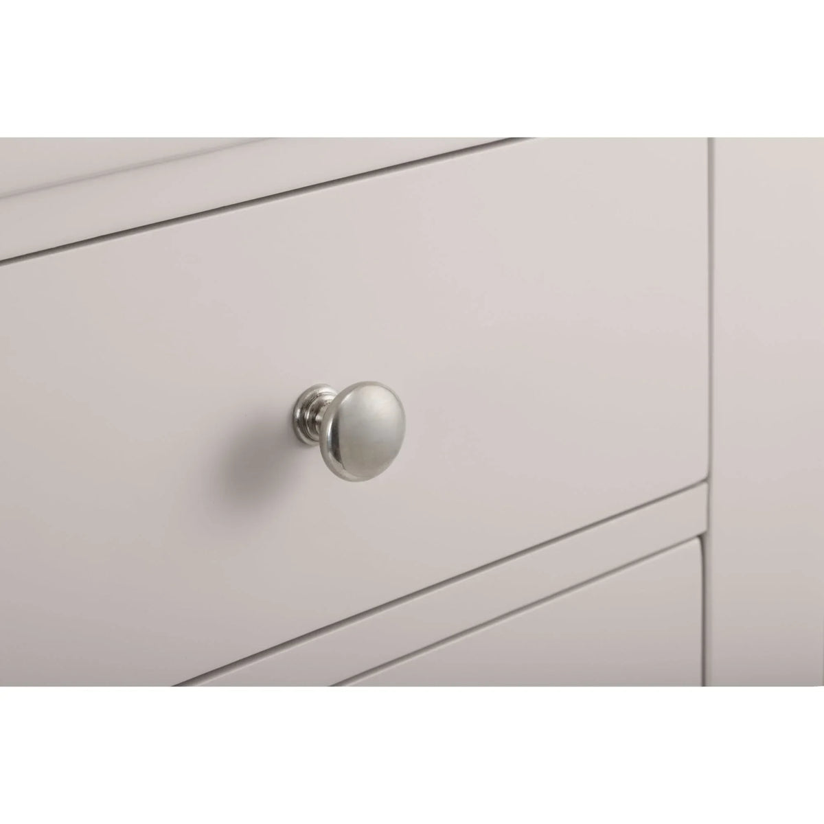 Light grey drawer chest with brushed metal knob detail and smooth painted finish