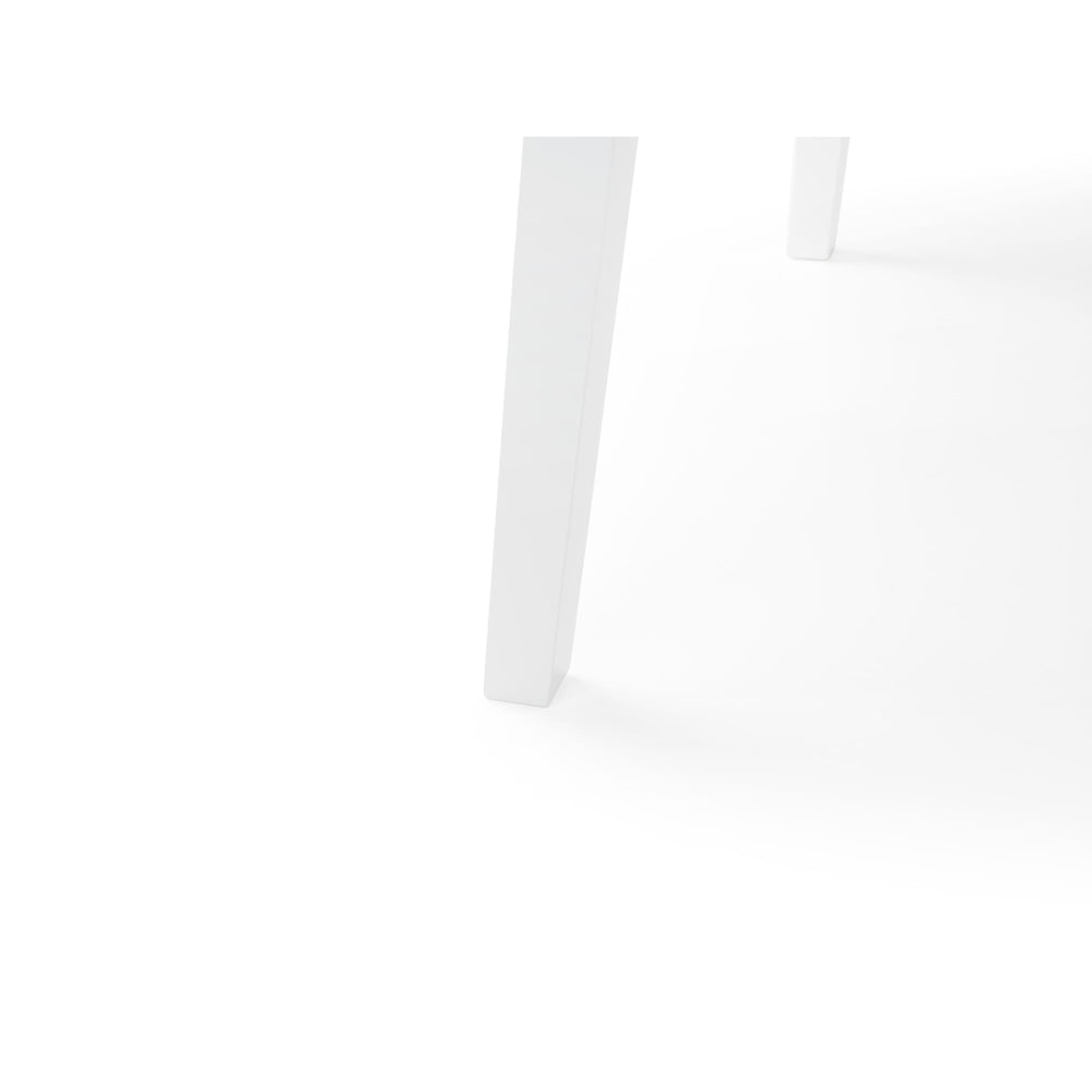 Close-up of white table tapered legs and rounded edge on white background.