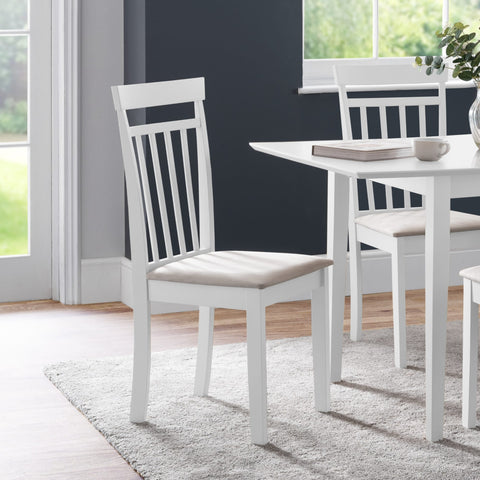White wooden dining chair with beige cushioned seat angled left in modern dining room