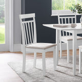 White wooden dining chair with beige cushioned seat angled left in modern dining room