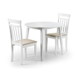 Two white wooden chairs with beige cushions placed at a round white dining table.