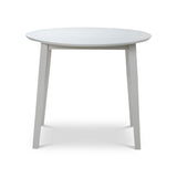 Round white wooden table with angled legs on white background