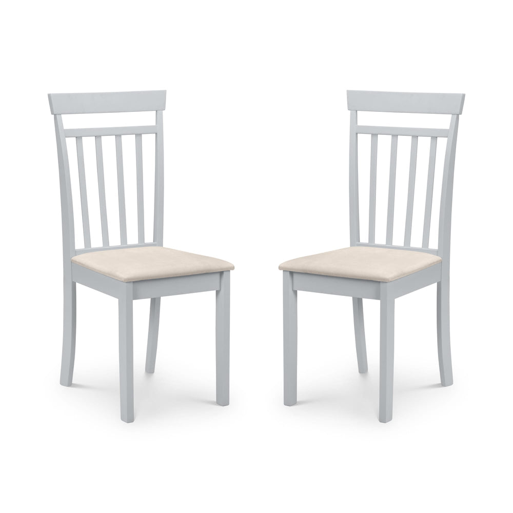 Pair of white dining chairs with vertical slat backs and beige upholstered seats, angled view on white background.