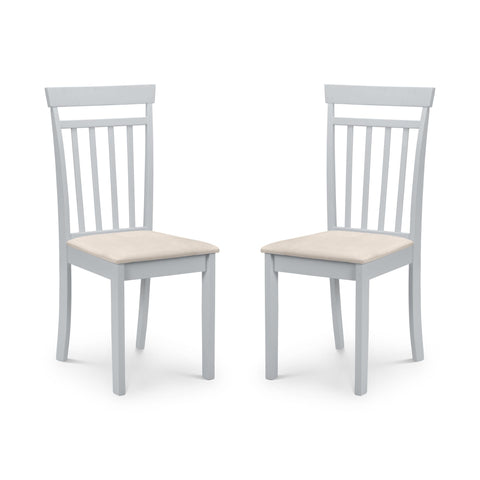 Pair of white dining chairs with vertical slat backs and beige upholstered seats, angled view on white background.