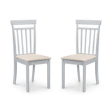 Pair of white dining chairs with vertical slat backs and beige upholstered seats, angled view on white background.