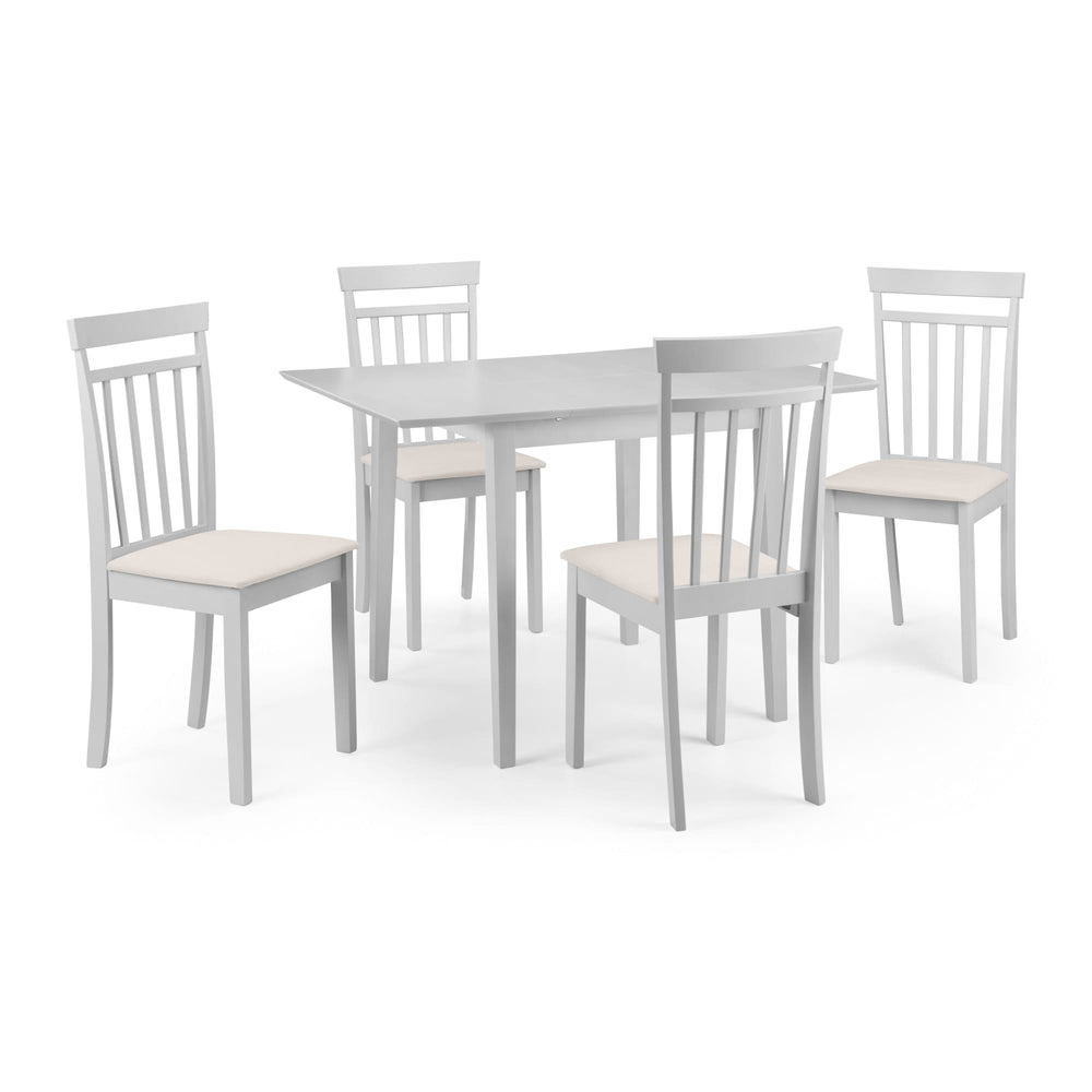 Set of four white dining chairs with beige seats arranged around pale rectangular dining table on white background.