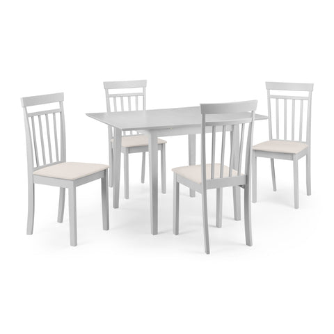 Set of four white dining chairs with beige seats arranged around pale rectangular dining table on white background.