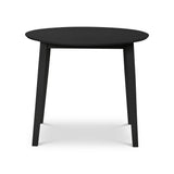 Black round wooden table with four straight legs isolated on white background