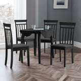 Round black wooden table with all dropleaf sections unfolded