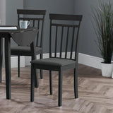 Two black wooden dining chairs with vertical slats and dark fabric seats beside a black drop-leaf table