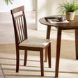 Single brown wooden dining chair with beige cushioned seat beside round wooden table in bright room
