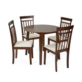Set of two dark wood dining chairs with beige cushions alongside small round dining table on white background