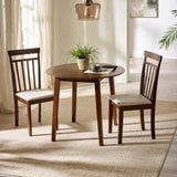 Round dark wood dining table with two matching chairs with beige cushions in bright room with rug