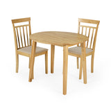 Two light wood dining chairs with beige padded seats and a round wooden table on white background