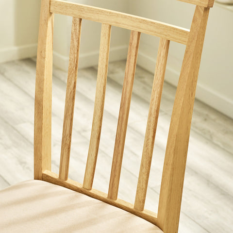 Close-up of vertical wooden slats and cushioned seat of dining chair on light wood floor