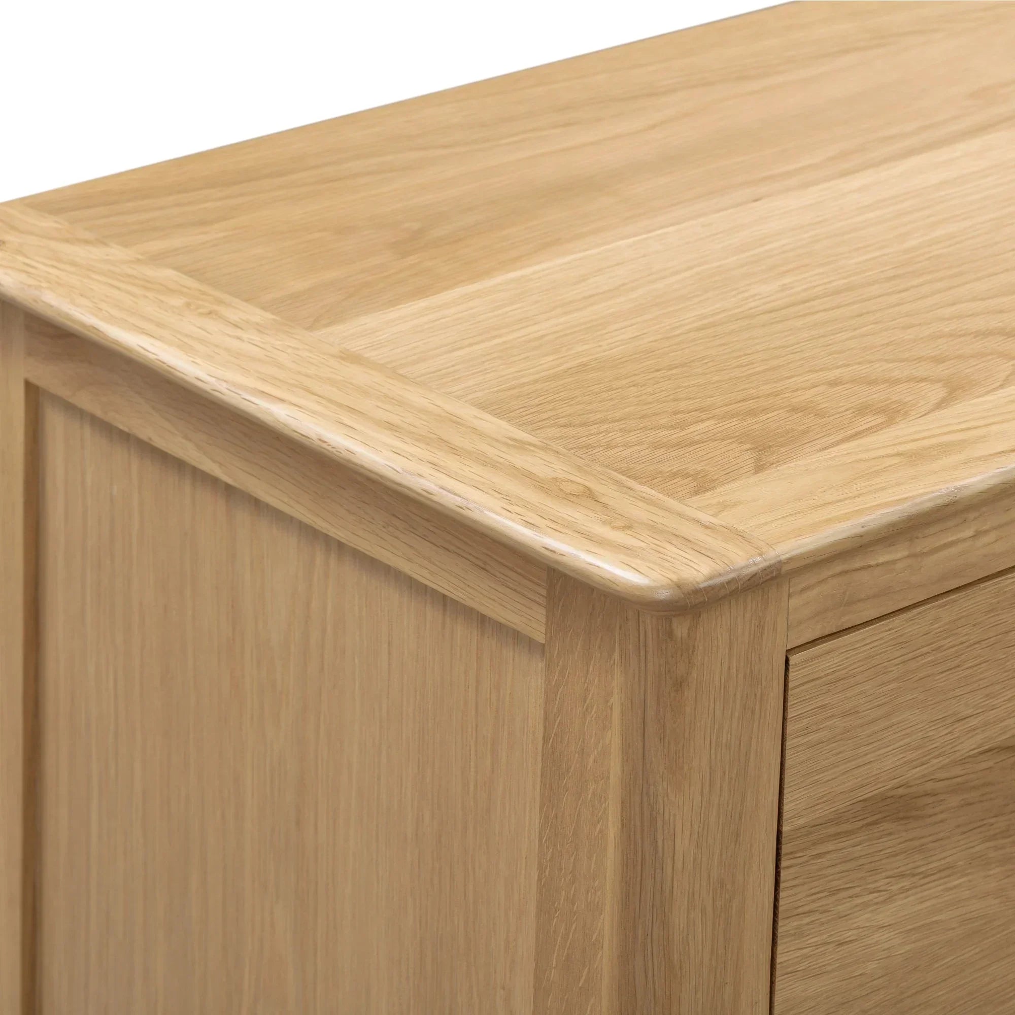 Oak wood finish on Cotswold 3 drawer bedside table corner detail