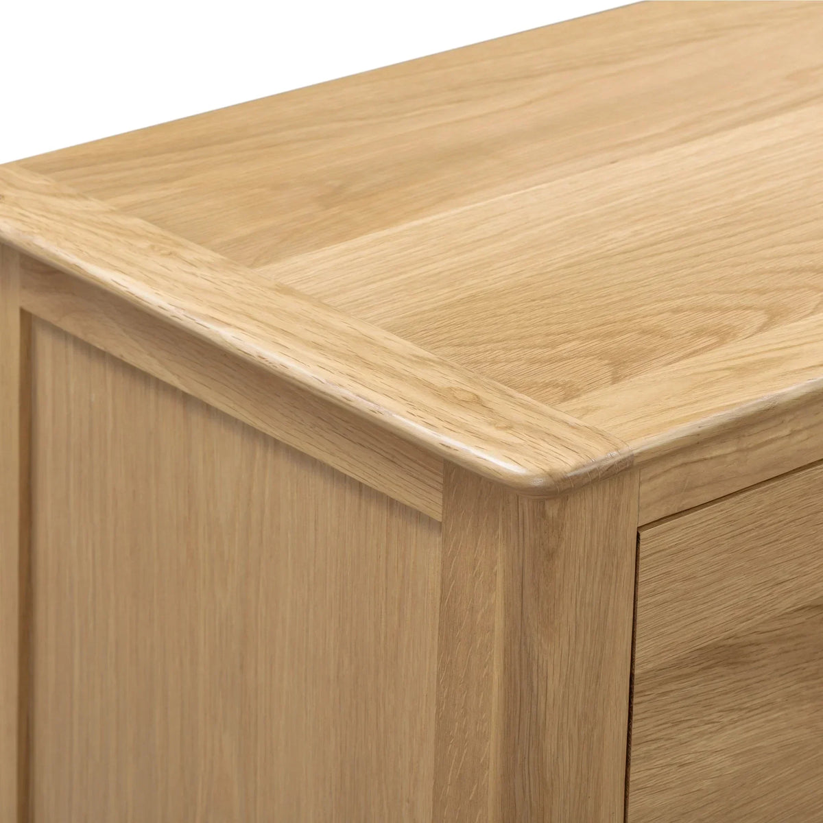 Oak wood finish on Cotswold 3 drawer bedside table corner detail