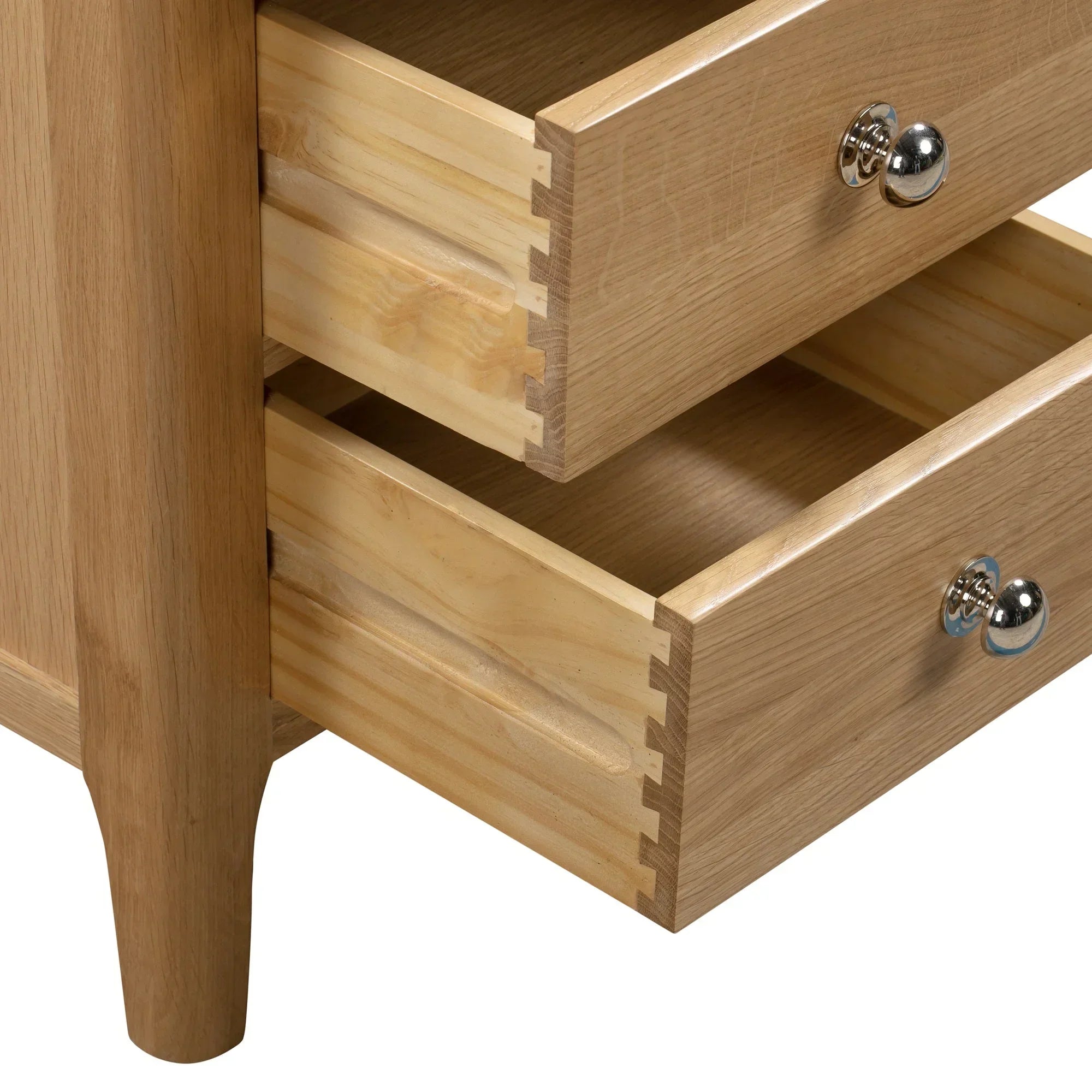 Open drawers detail on oak 3 drawer bedside table with metal knobs