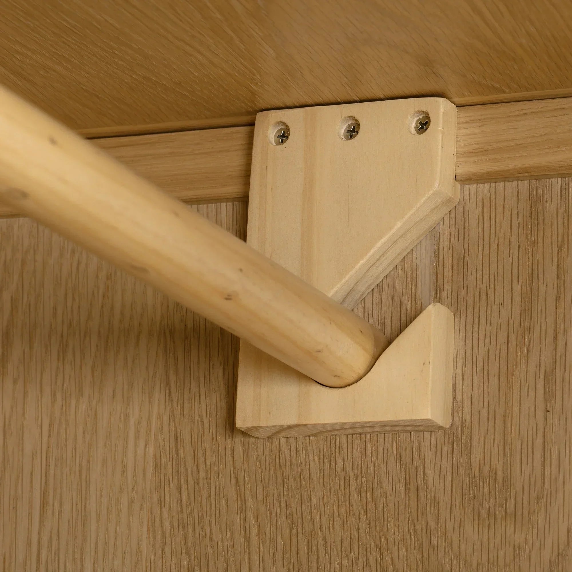 Oak wardrobe interior showing hanging rail and wooden bracket detail