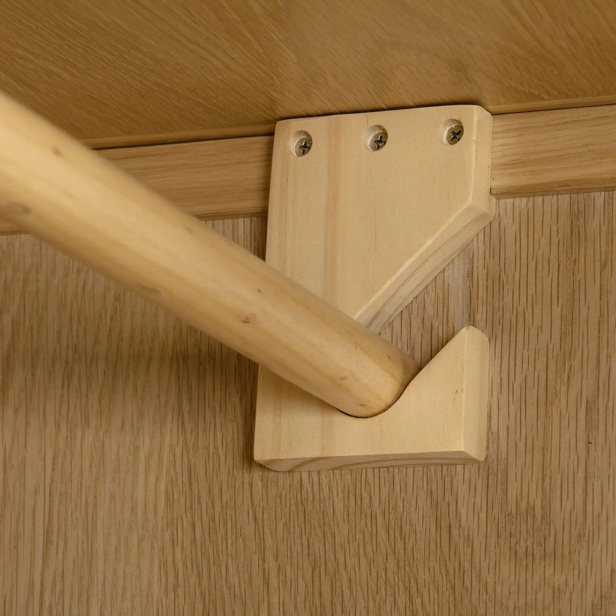 Oak wardrobe interior showing hanging rail and wooden bracket detail