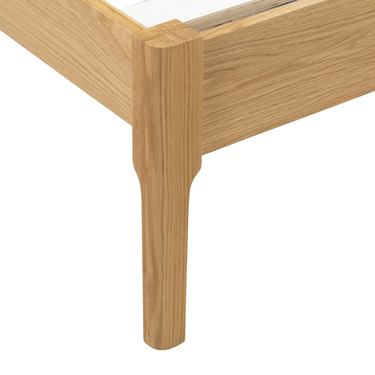 Double bed oak frame corner detail showing solid wood leg and grain pattern