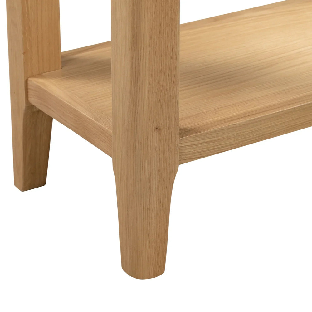 Oak console table leg and lower shelf detail in natural wood finish