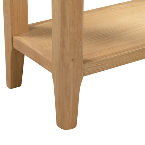 Oak console table leg and lower shelf detail in natural wood finish
