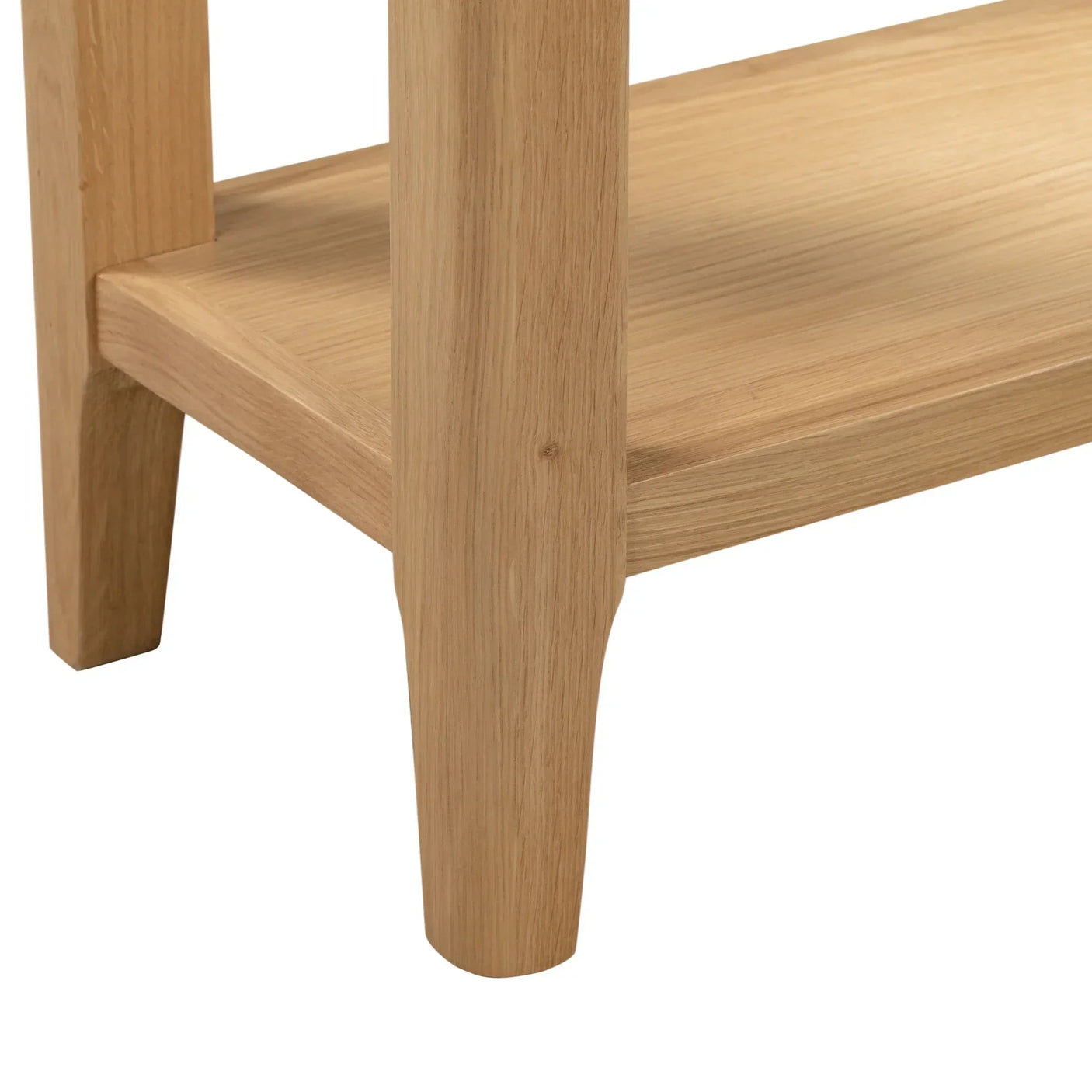 Oak console table leg and lower shelf detail in natural wood finish