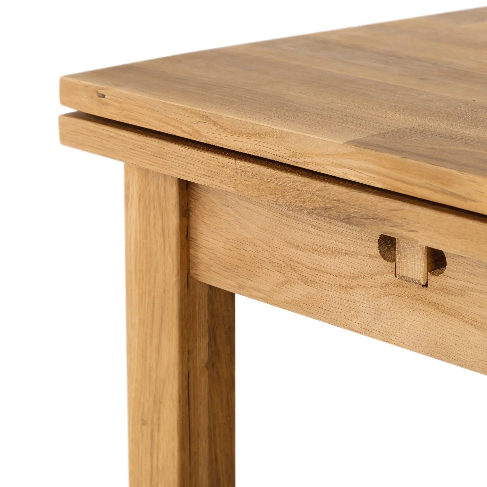 Close up of oak extending dining table corner showing wood grain and joinery detail