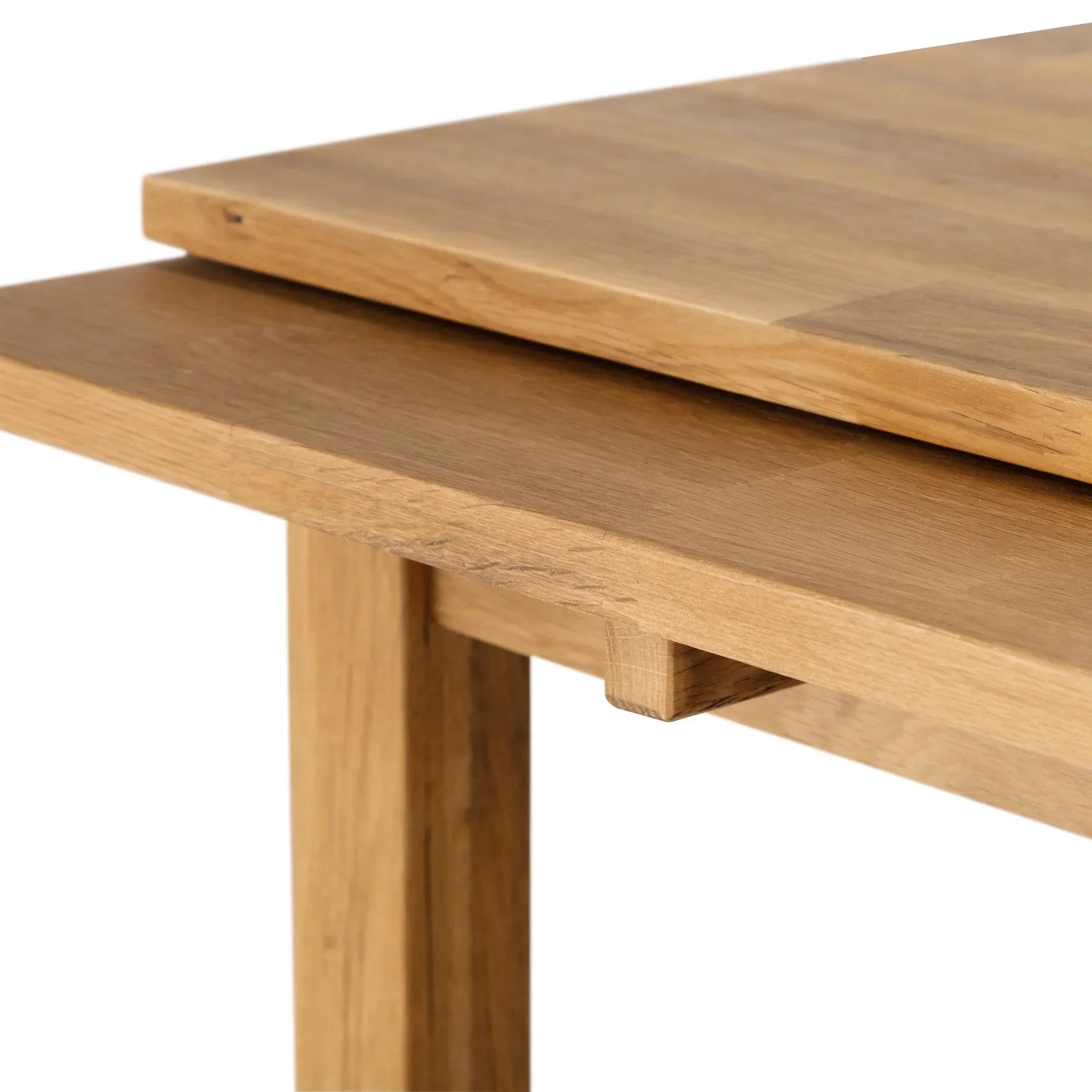 Close-up of oak extending dining table leaf mechanism and wood grain texture