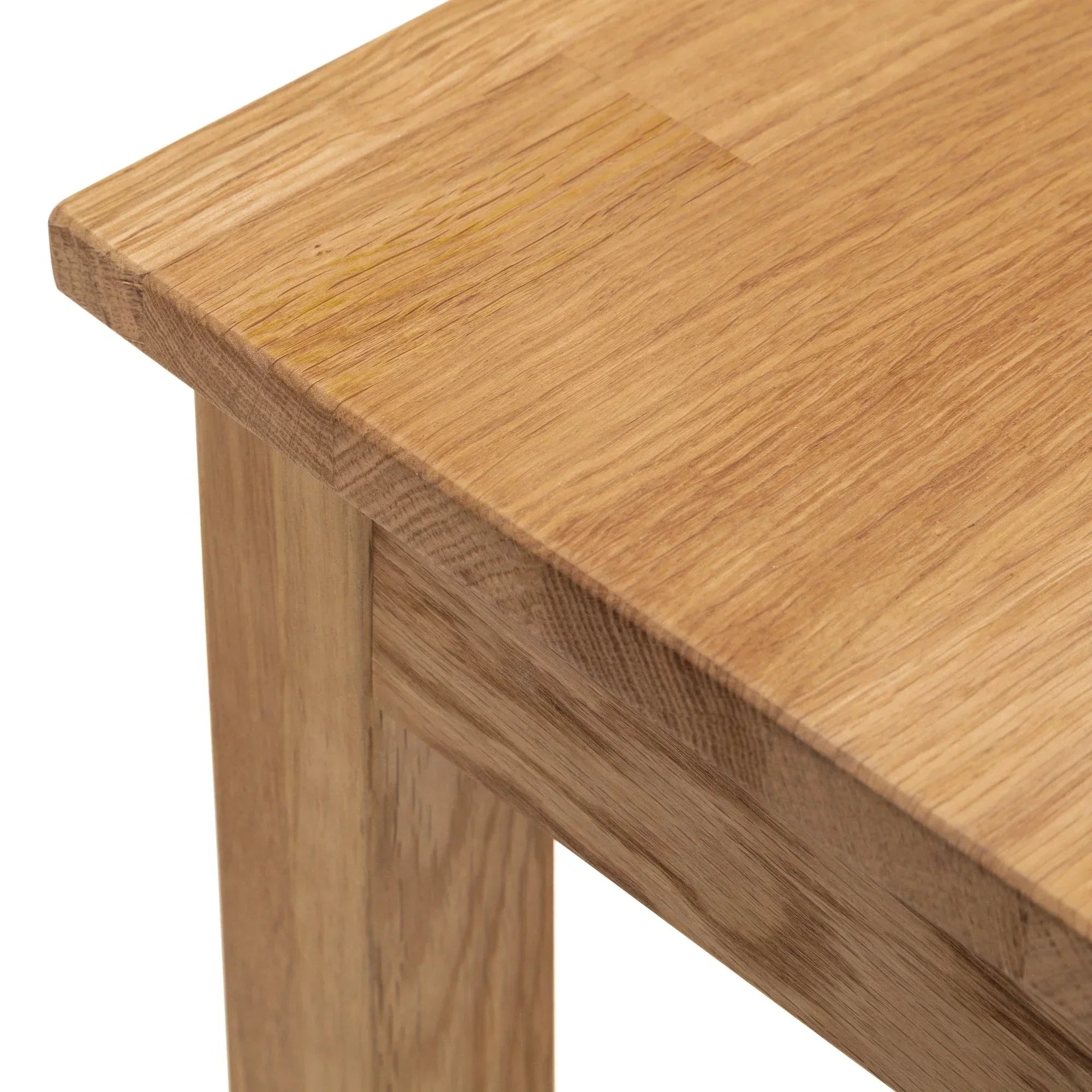 Close-up of oak console table corner with visible wood grain and smooth finish