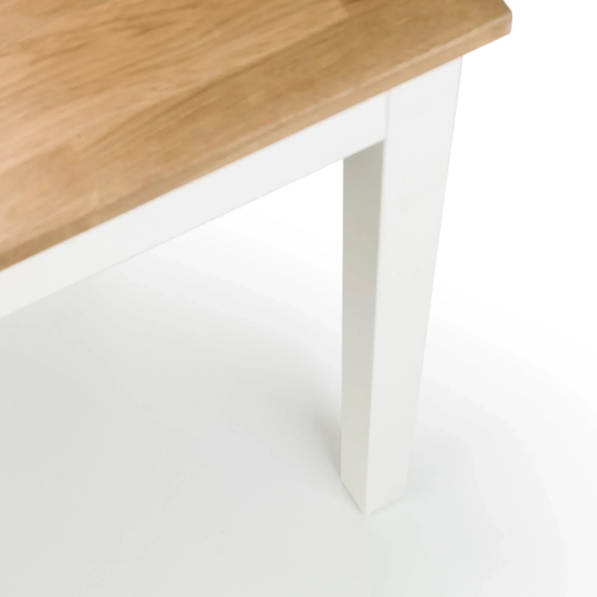 Rectangular dining table with ivory painted leg and natural oak wood top closeup