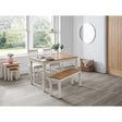Rectangular ivory oak dining table set with bench and chairs in bright dining room