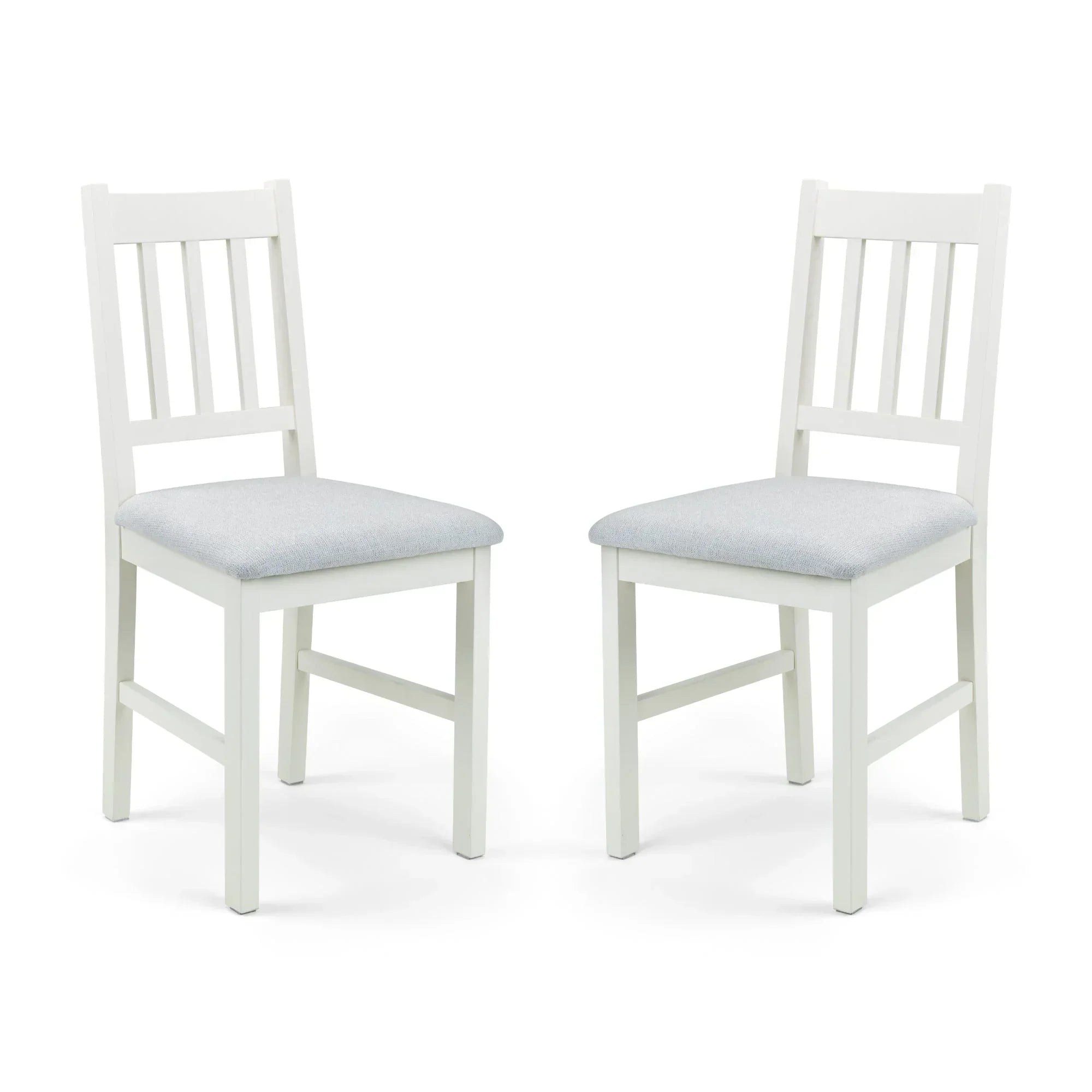 Ivory dining chair pair with cushioned seats and slatted backs on white background