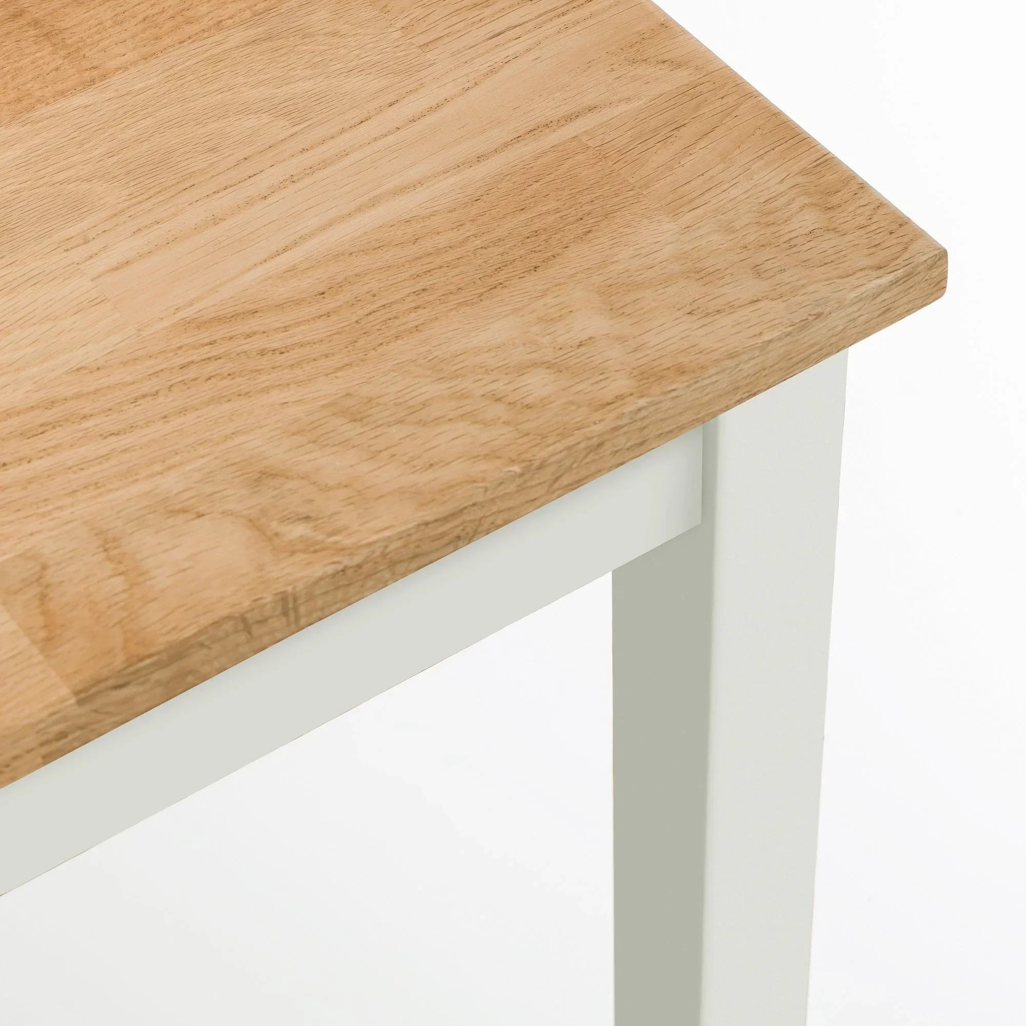 Oak dining table corner with ivory painted leg and wood grain detail