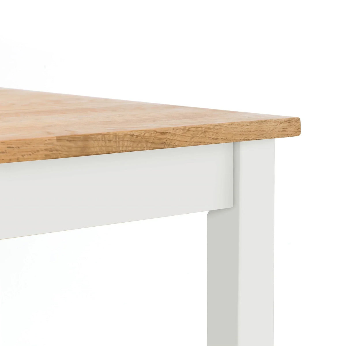 Oak dining table corner with ivory painted legs and wood grain detail