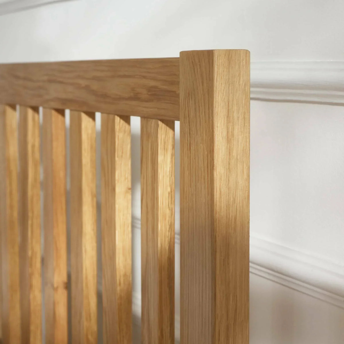 Oak double bed headboard with vertical slats and natural wood grain detail
