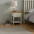 Ivory oak bedside table with single drawer, lamp, and books in modern bedroom setting