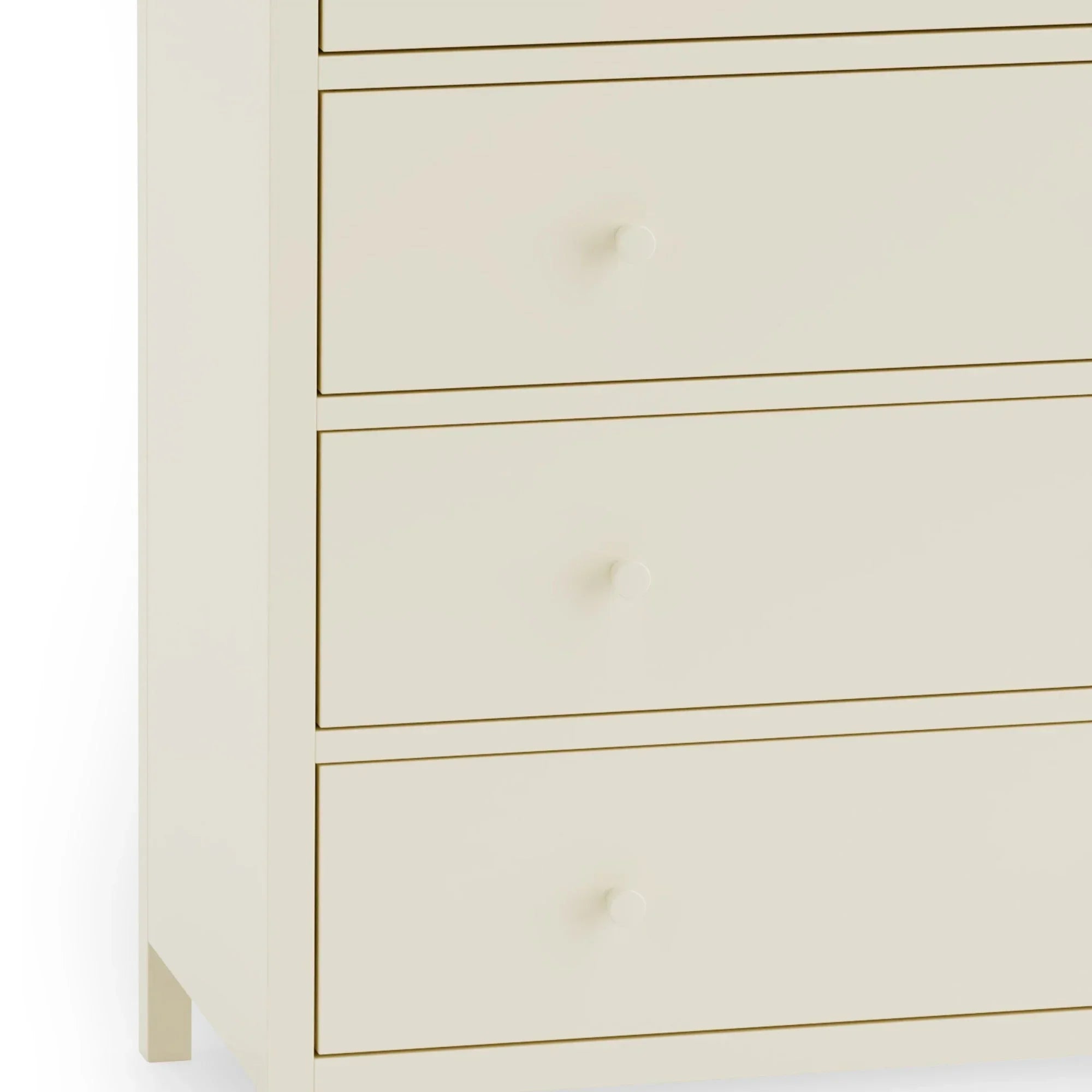 Cream chest of drawers with round knobs and smooth drawer fronts, close-up view