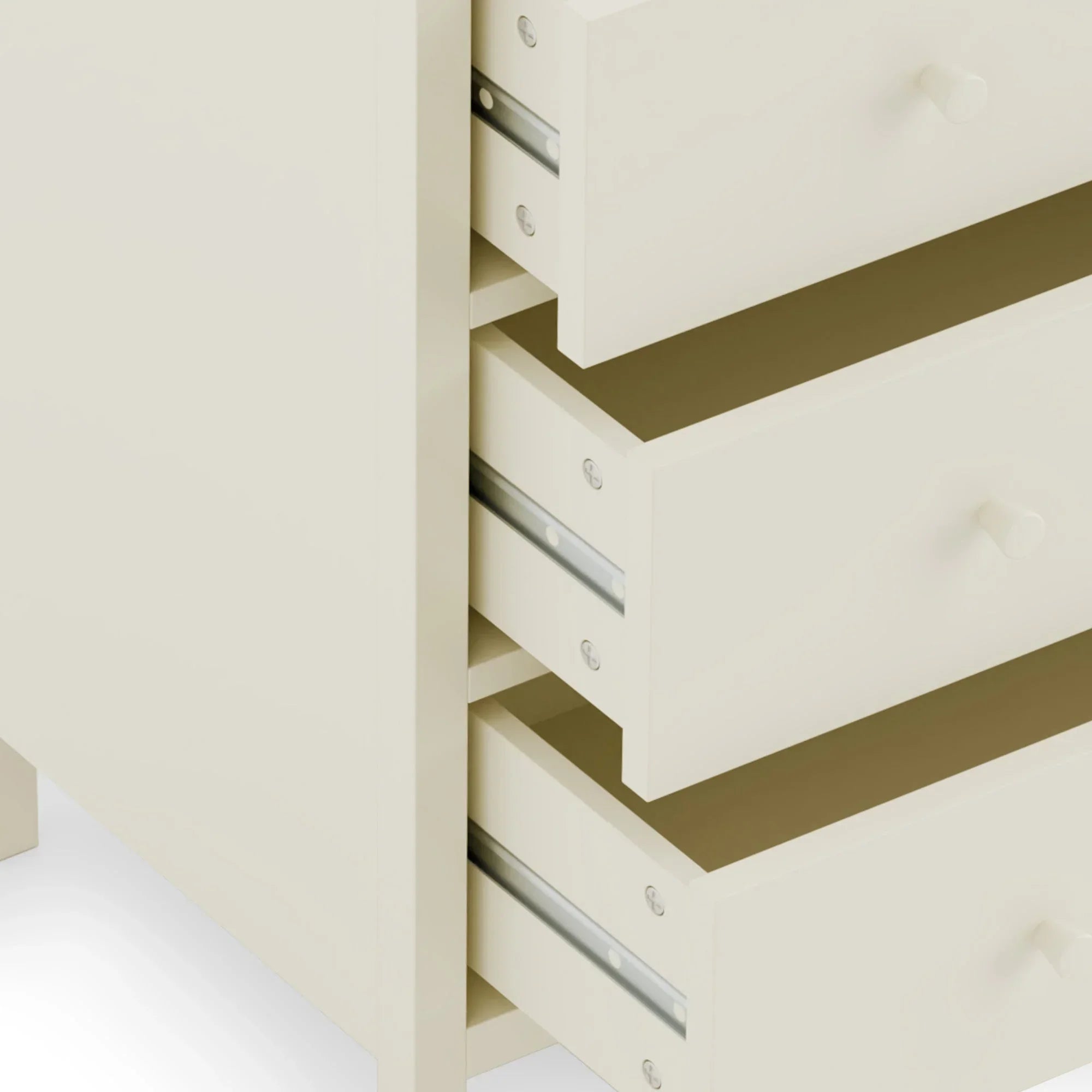 Cream chest of drawers with smooth runners and round knobs, close-up side view
