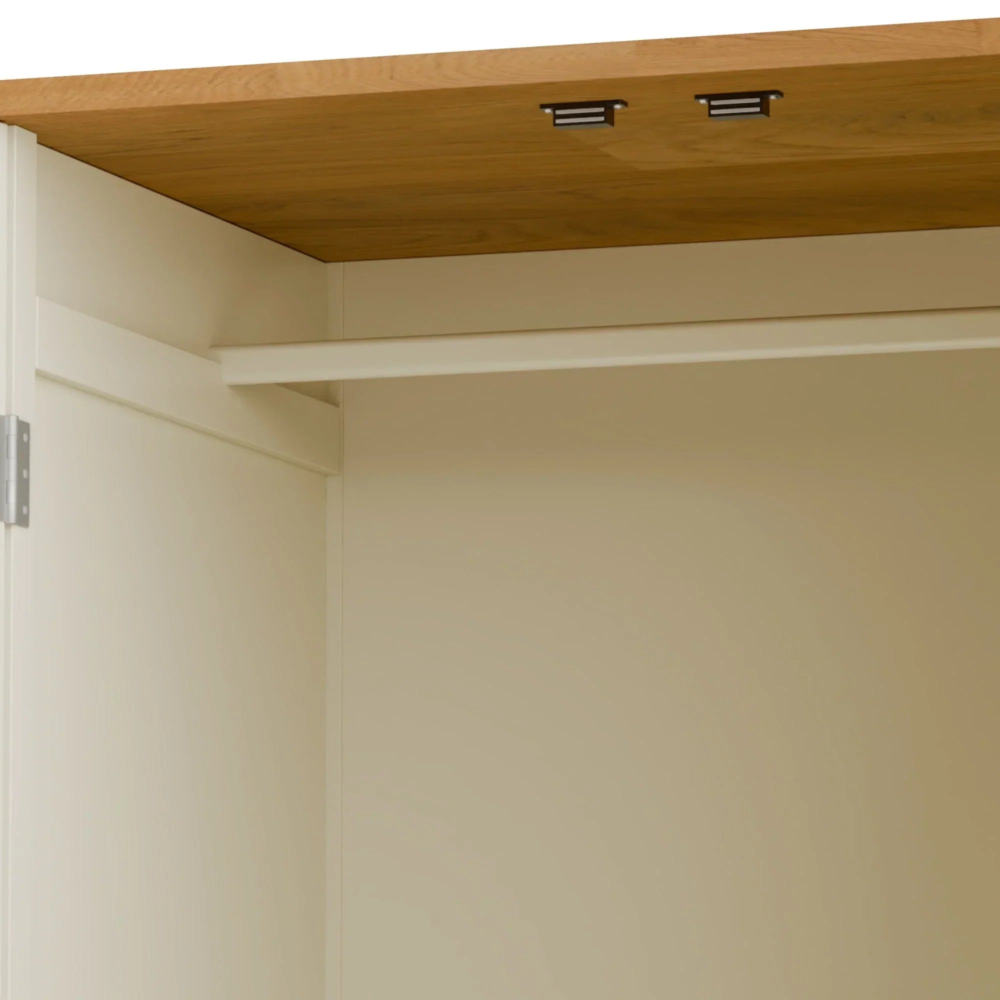 Cream wardrobe interior with hanging rail and oak effect top panel