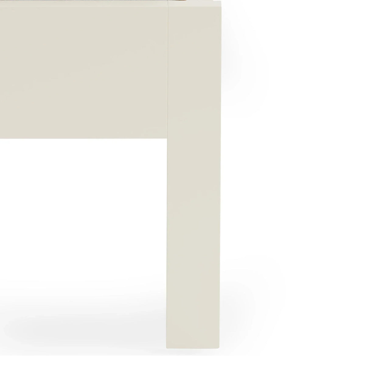 Close-up of cream dining table leg with smooth finish and modern square design