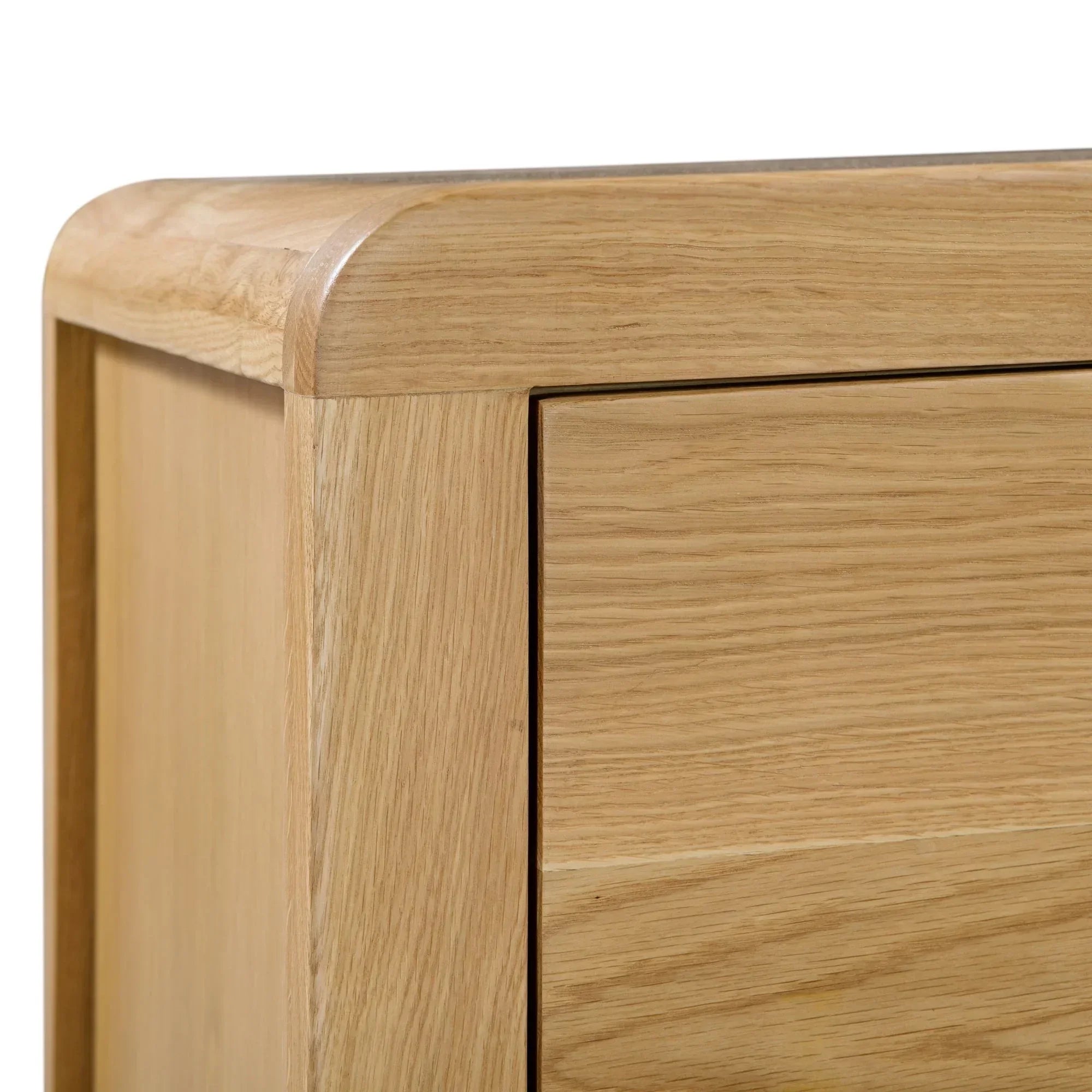 Oak bedside table closeup showing curved corner and wood grain drawer detail